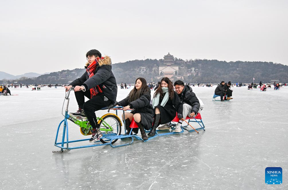Tourists have fun on frozen lake at Summer Palace in Beijing
