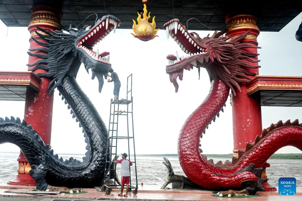 Workers repaint dragon statues in preparation for upcoming Chinese Lunar New Year in Indonesia