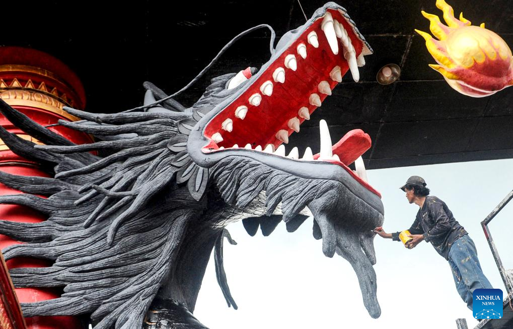 Workers repaint dragon statues in preparation for upcoming Chinese Lunar New Year in Indonesia