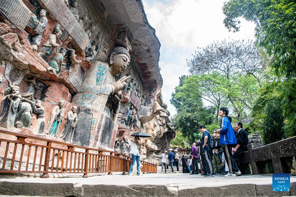 Tourists visit Dazu Rock Carvings in Chongqing