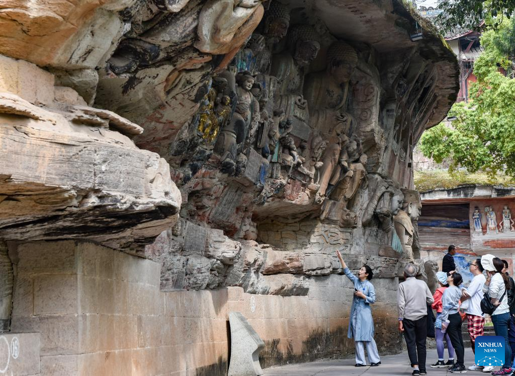 Tourists visit Dazu Rock Carvings in Chongqing