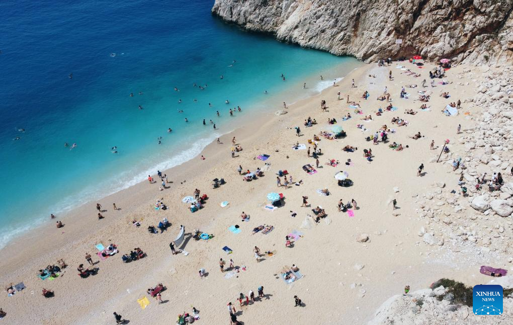 Tourists enjoy leisure time at Kaputas Beach in Kas District, Türkiye