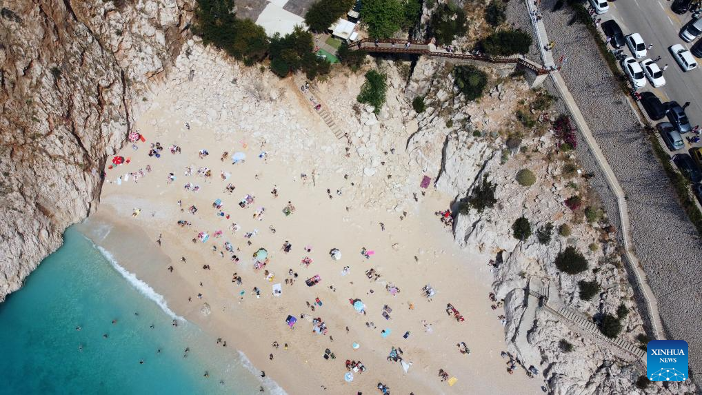 Tourists enjoy leisure time at Kaputas Beach in Kas District, Türkiye