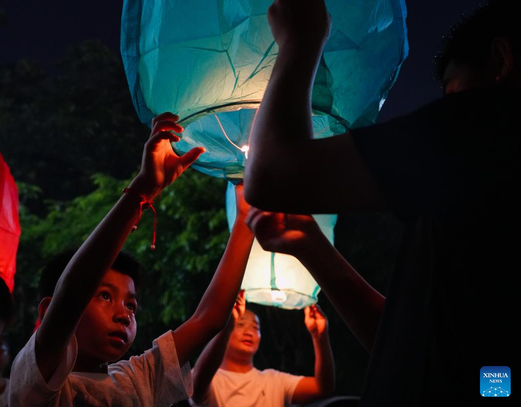 People fly Kongming lanterns to celebrate New Year of calendar of Dai ethnic group