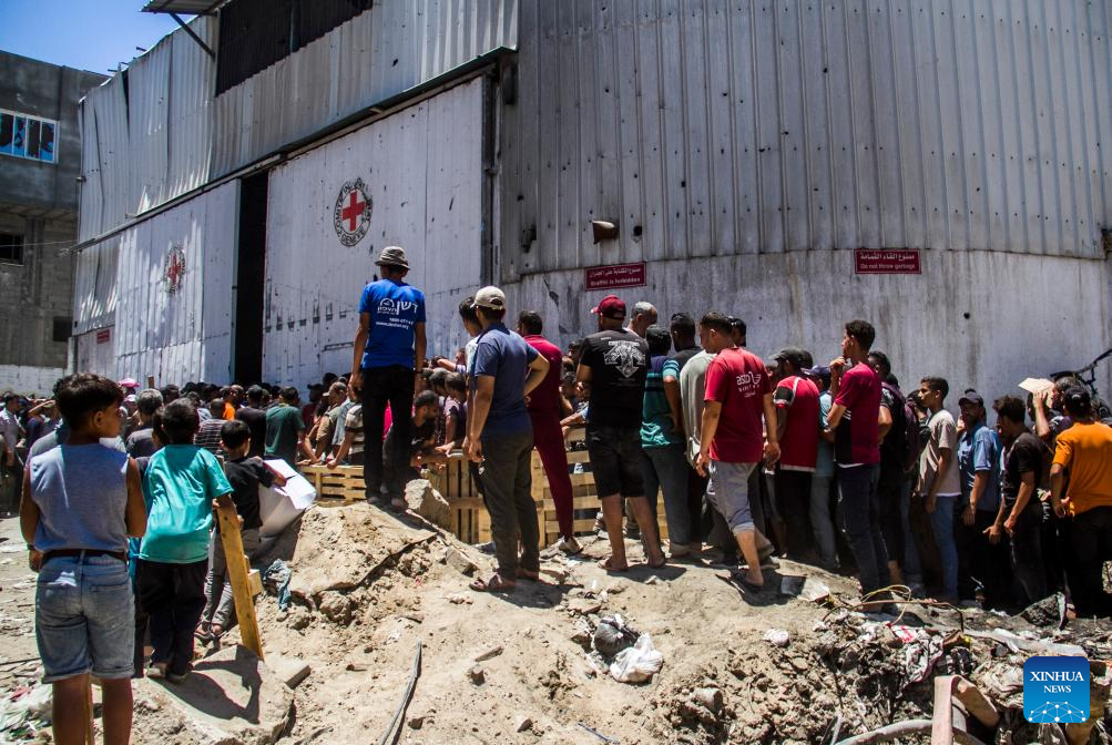 Palestinians gather to receive food aid in Gaza