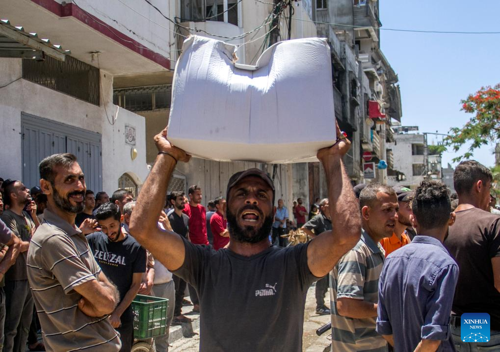 Palestinians gather to receive food aid in Gaza