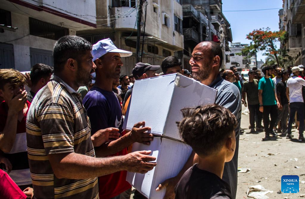 Palestinians gather to receive food aid in Gaza