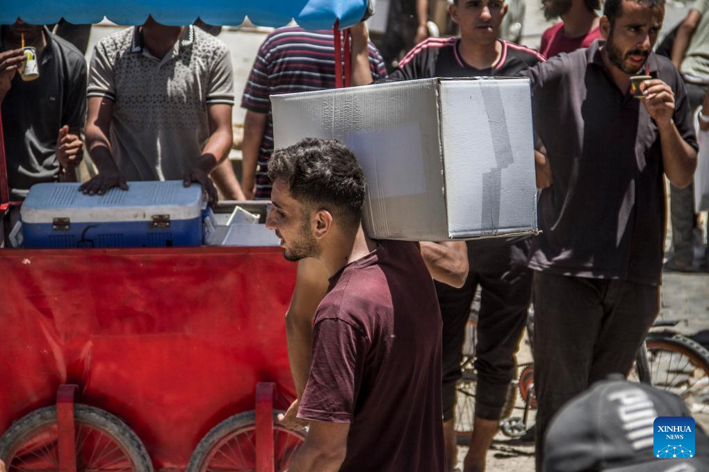 Palestinians gather to receive food aid in Gaza