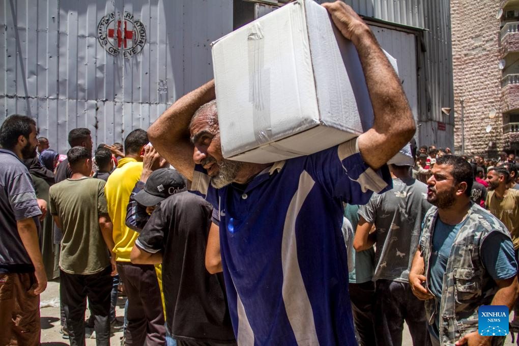 Palestinians gather to receive food aid in Gaza