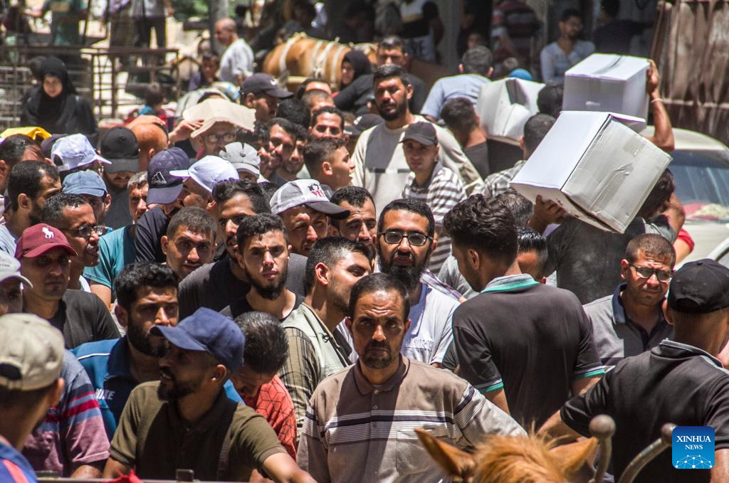 Palestinians gather to receive food aid in Gaza