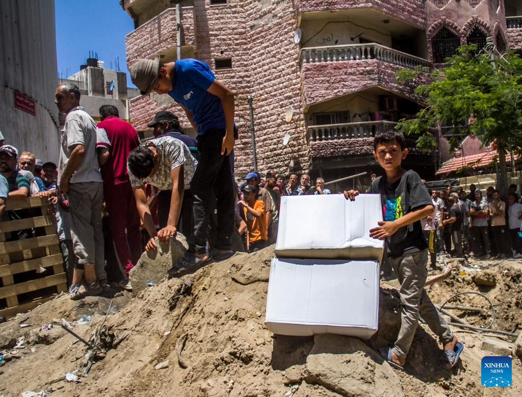 Palestinians gather to receive food aid in Gaza