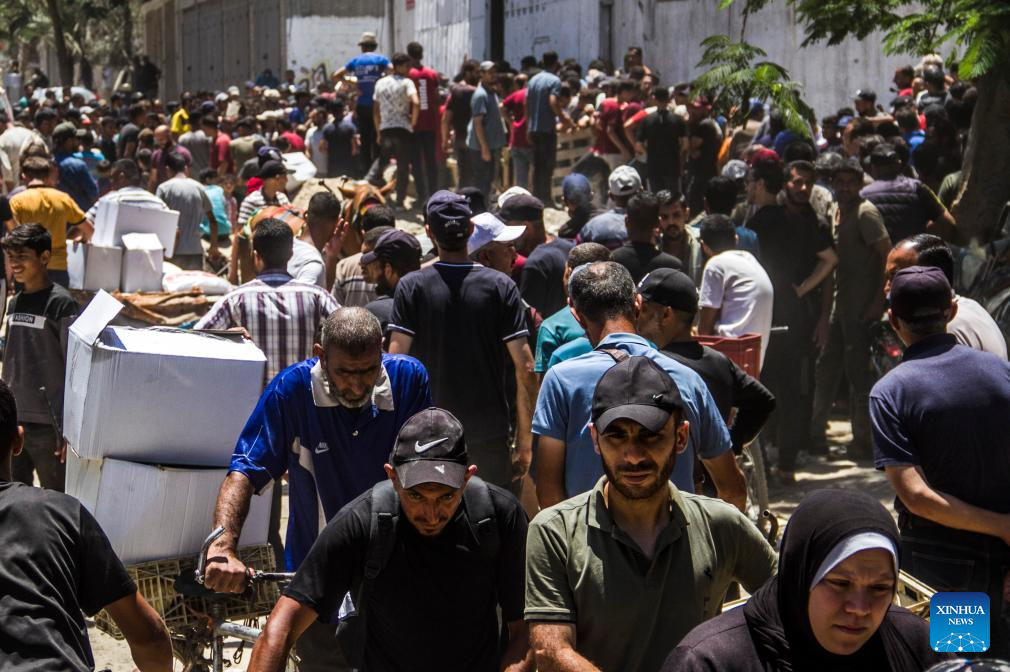 Palestinians gather to receive food aid in Gaza