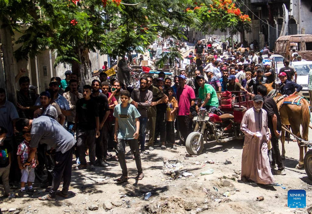 Palestinians gather to receive food aid in Gaza