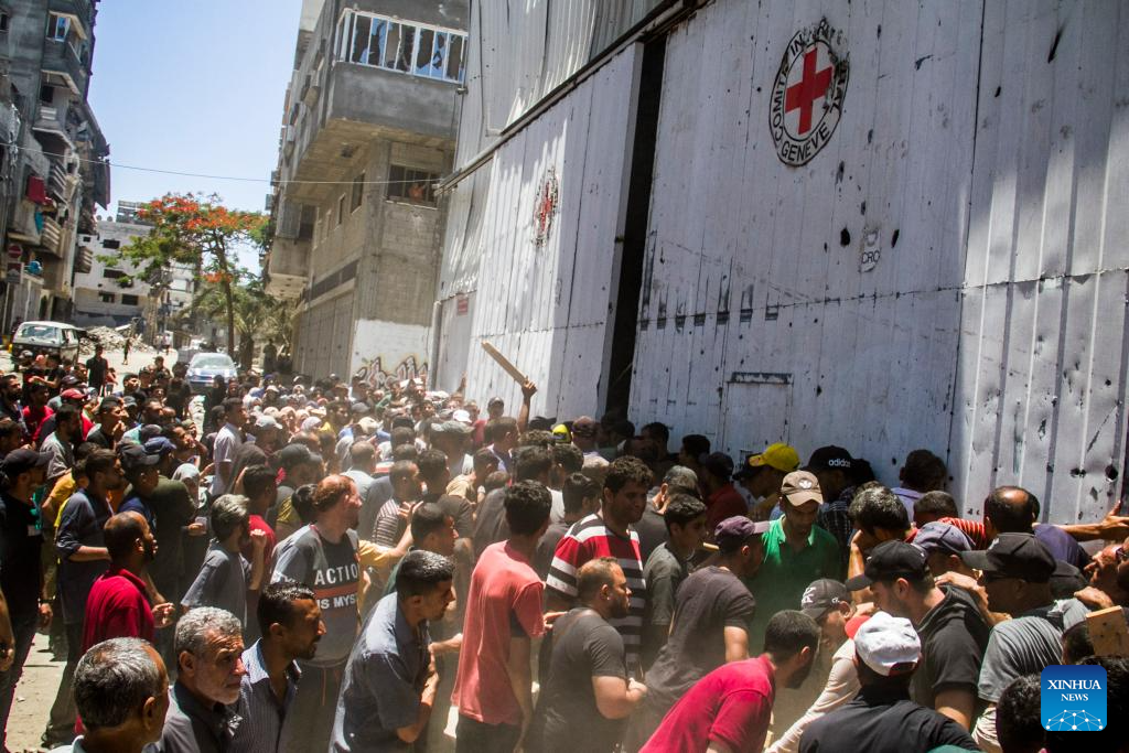 Palestinians gather to receive food aid in Gaza