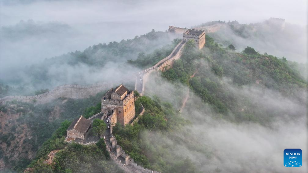 Scenery of Jinshanling section of Great Wall shrouded in clouds in Hebei