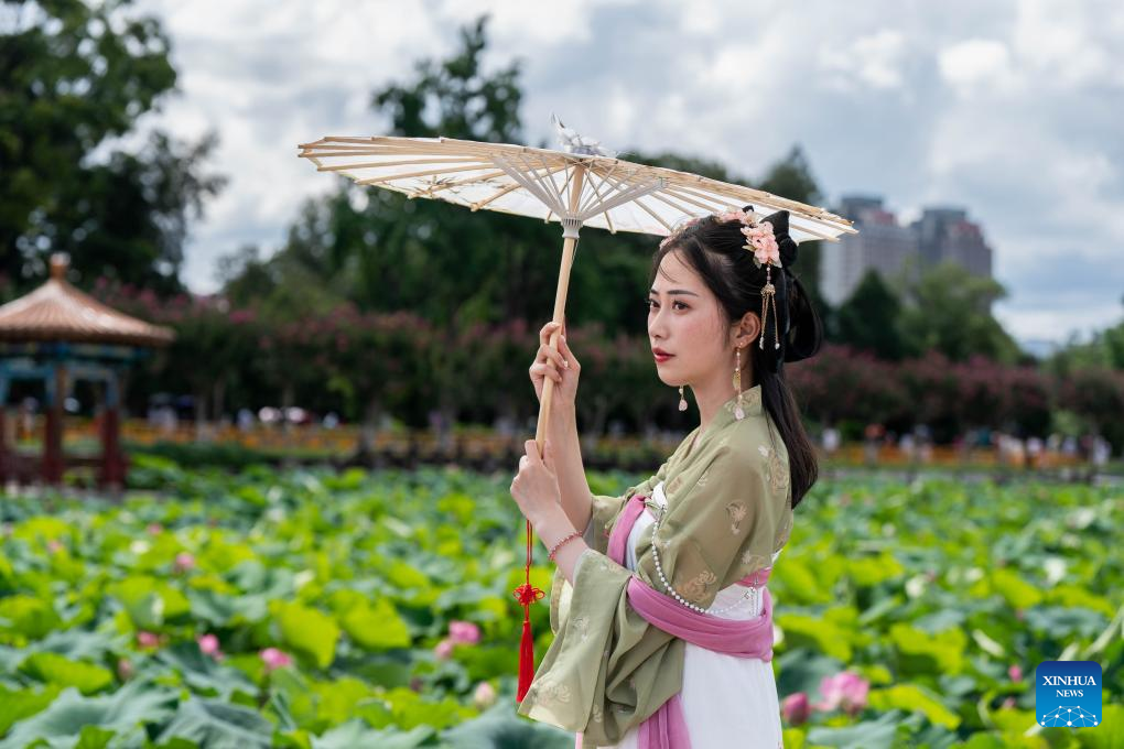 Visitors enjoy lotus flowers at Daguan Park in Kunming