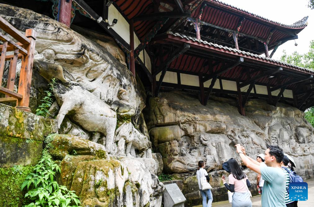 Tourists visit scenic spot of Dazu Rock Carvings in China's Chongqing