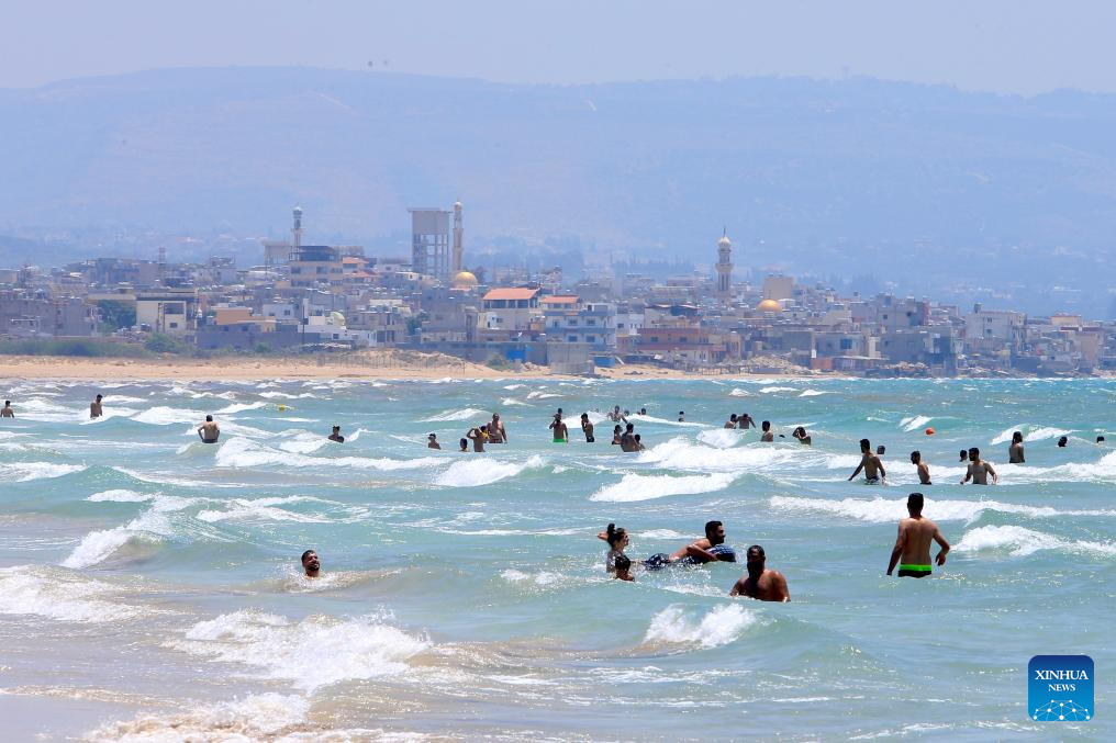 People have fun at seaside in Tyre, Lebanon