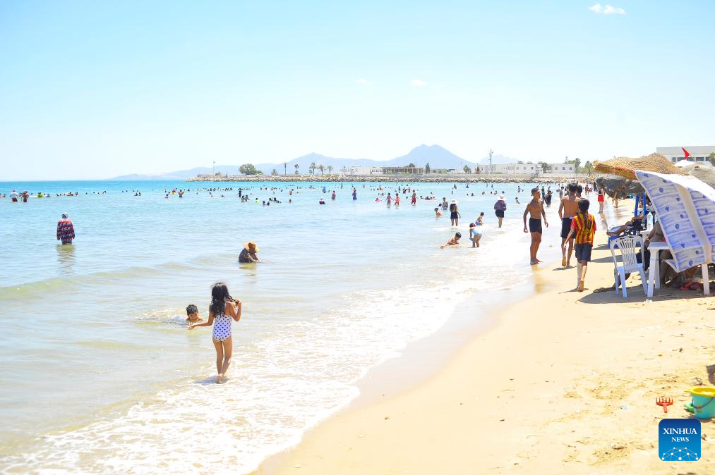 People cool off by seaside during heat wave in Tunis