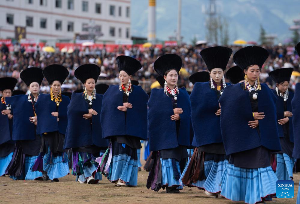 People dressed in traditional Yi costumes celebrate torch festival in China's Sichuan