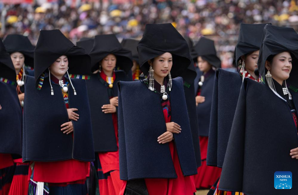 People dressed in traditional Yi costumes celebrate torch festival in China's Sichuan