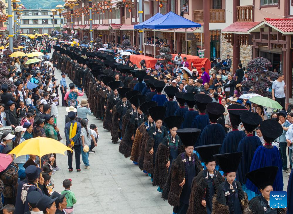 People dressed in traditional Yi costumes celebrate torch festival in China's Sichuan