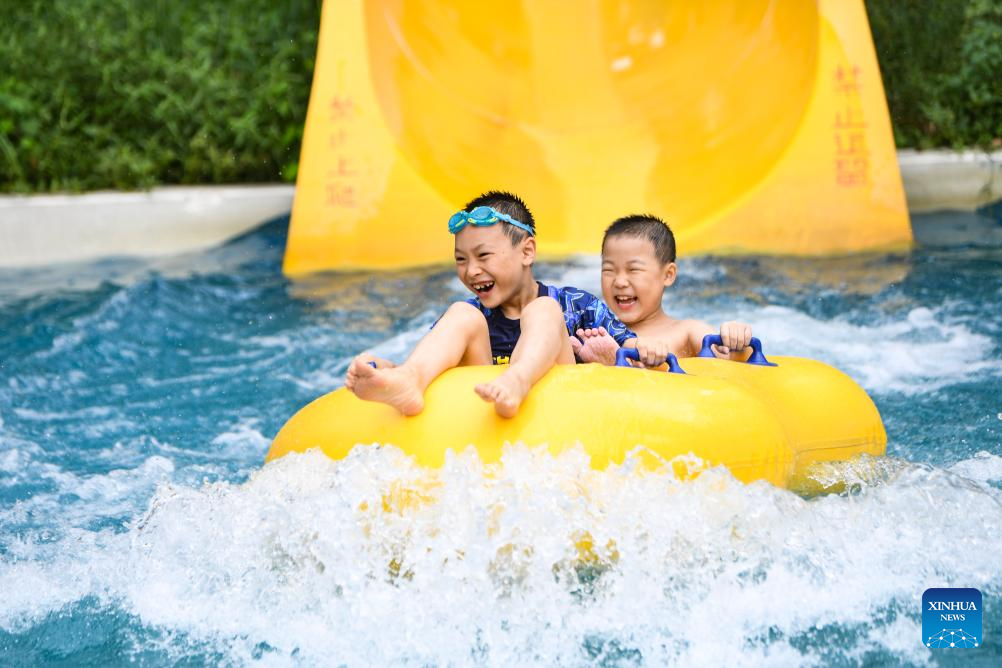 Tourists have fun at water park in Fuling District, SW China's Chongqing