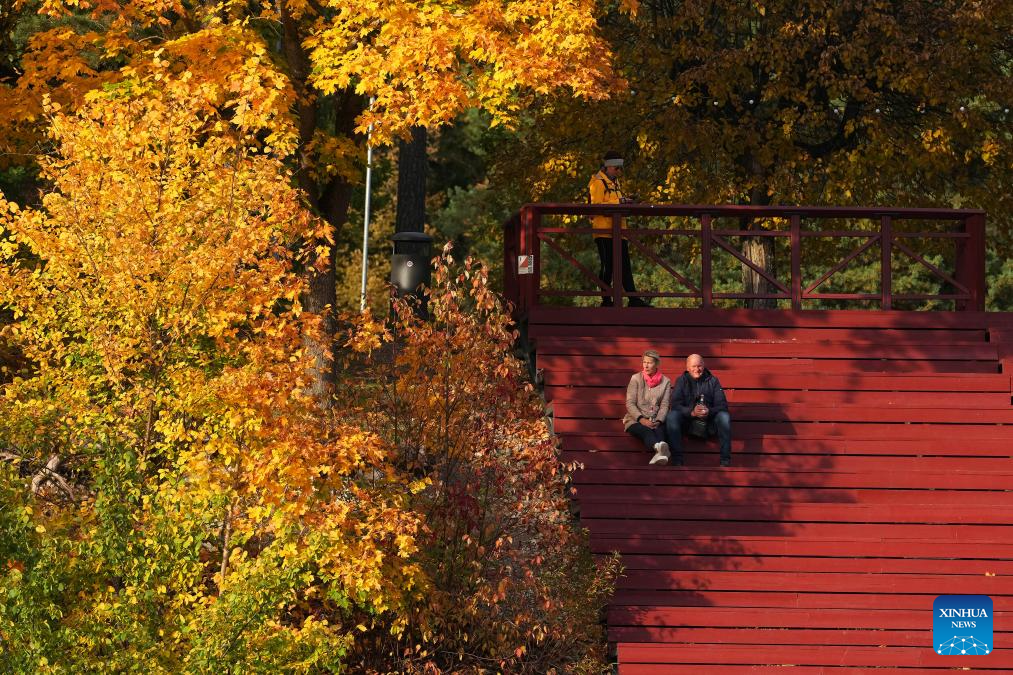 People enjoy autumn scenery in Ogre, Latvia