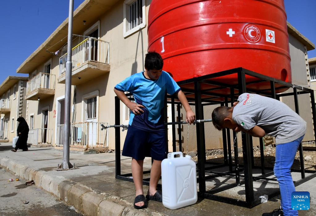 People fleeing from Lebanon seen at Harjalleh shelter center in Syria