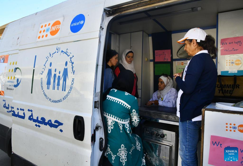 People fleeing from Lebanon seen at Harjalleh shelter center in Syria