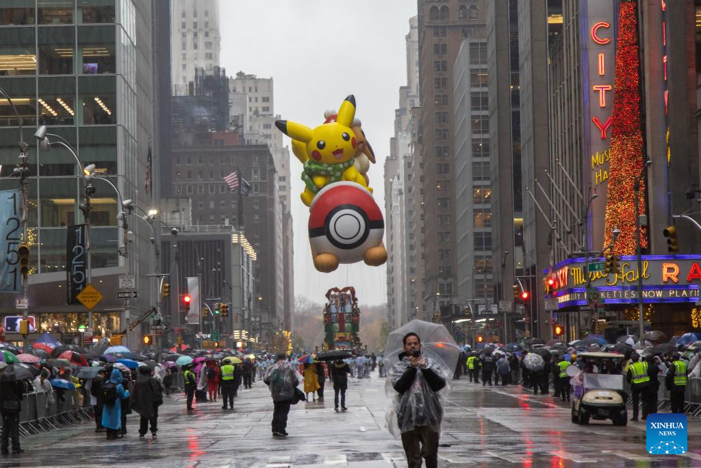 Feature: Spectators line up New York streets for Macy's Thanksgiving parade despite rain