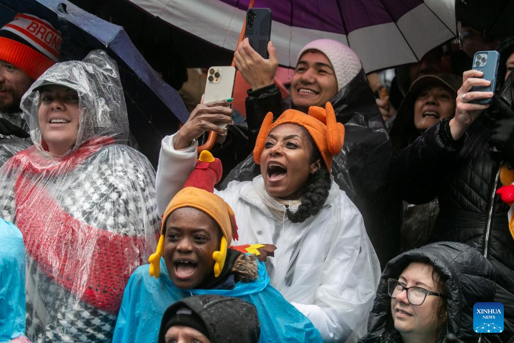 Feature: Spectators line up New York streets for Macy's Thanksgiving parade despite rain