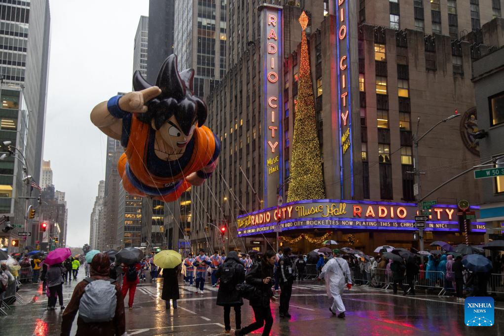 Feature: Spectators line up New York streets for Macy's Thanksgiving parade despite rain