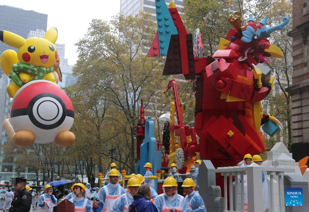 Feature: Spectators line up New York streets for Macy's Thanksgiving parade despite rain