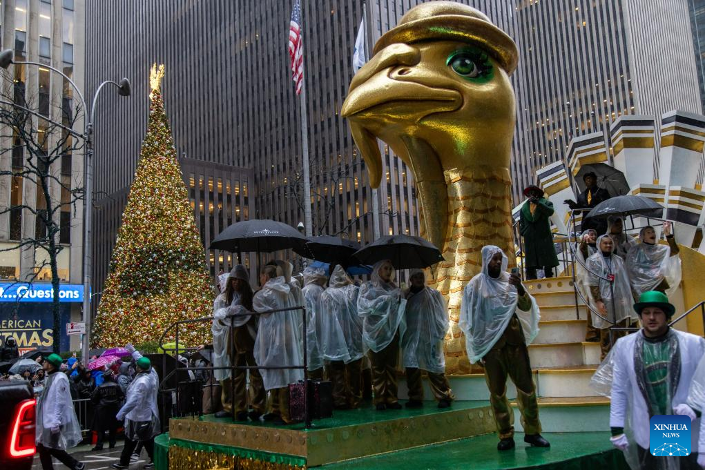 Feature: Spectators line up New York streets for Macy's Thanksgiving parade despite rain