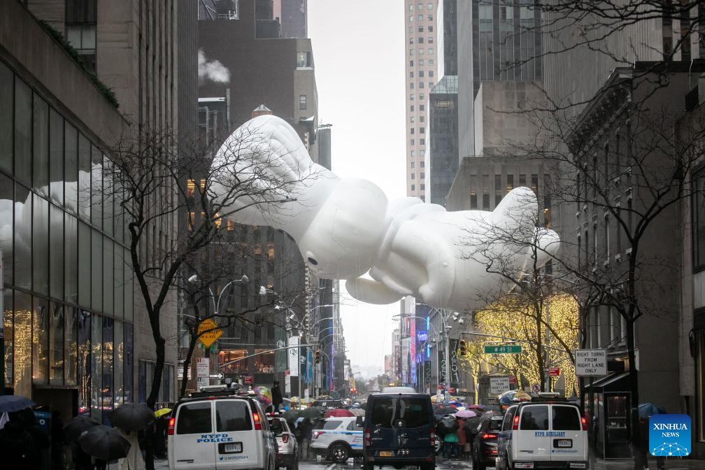 Feature: Spectators line up New York streets for Macy's Thanksgiving parade despite rain