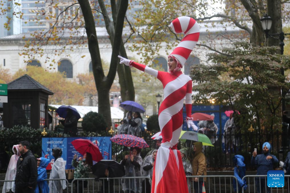 Feature: Spectators line up New York streets for Macy's Thanksgiving parade despite rain