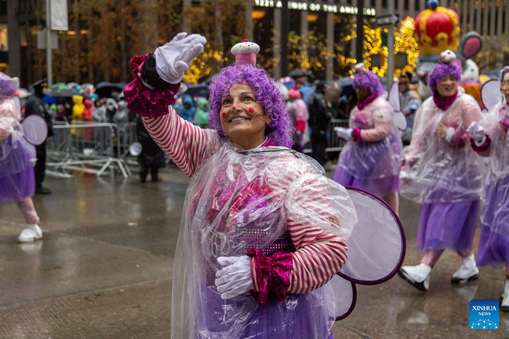 Feature: Spectators line up New York streets for Macy's Thanksgiving parade despite rain