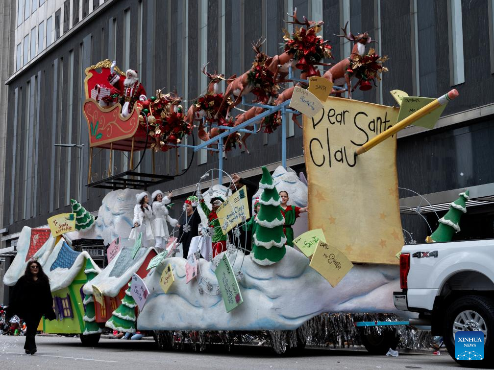 Feature: Spectators line up New York streets for Macy's Thanksgiving parade despite rain