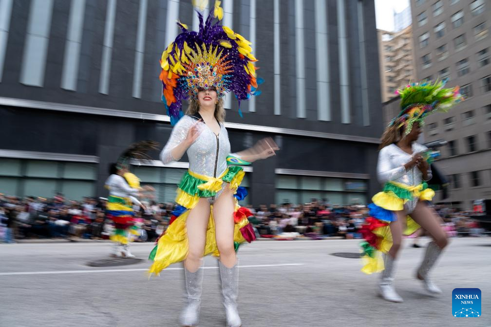 Feature: Spectators line up New York streets for Macy's Thanksgiving parade despite rain