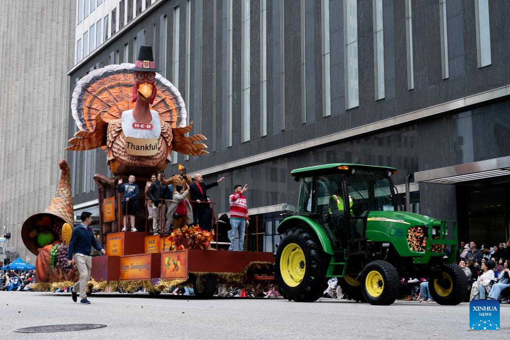 Feature: Spectators line up New York streets for Macy's Thanksgiving parade despite rain