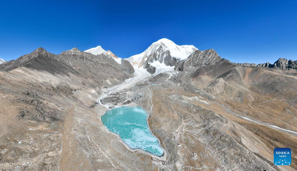 Tourists have fun on icy lake in Lhasa, China's Xizang