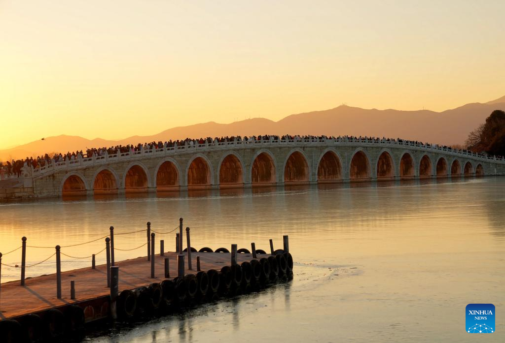 People visit 17-Arch Bridge in Summer Palace, China's Beijing