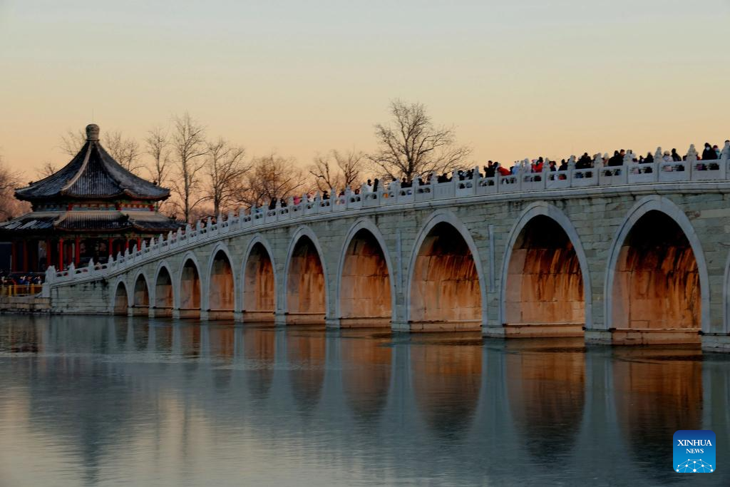 People visit 17-Arch Bridge in Summer Palace, China's Beijing