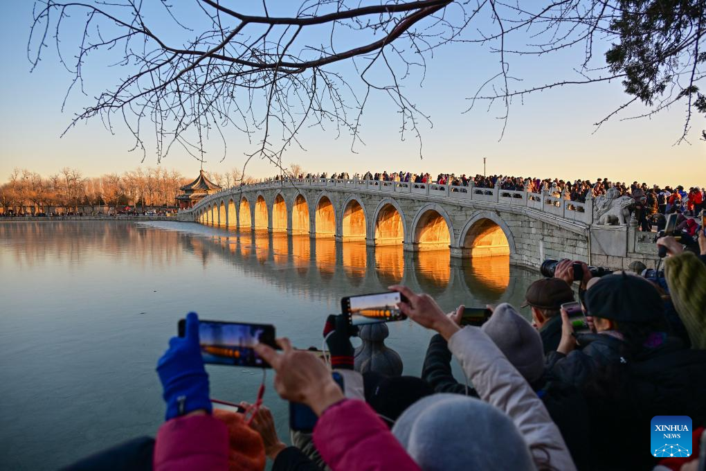 People visit 17-Arch Bridge in Summer Palace, China's Beijing