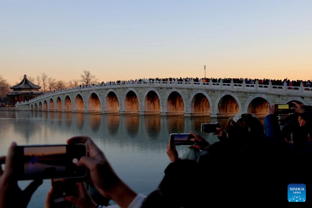 People visit 17-Arch Bridge in Summer Palace, China's Beijing