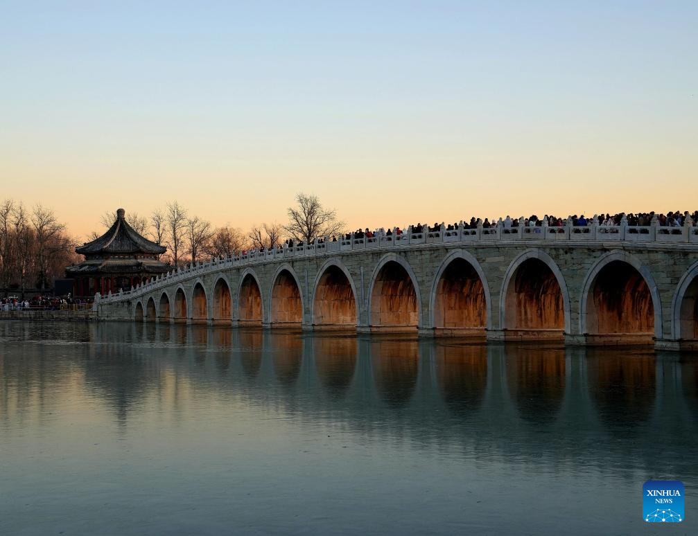 People visit 17-Arch Bridge in Summer Palace, China's Beijing