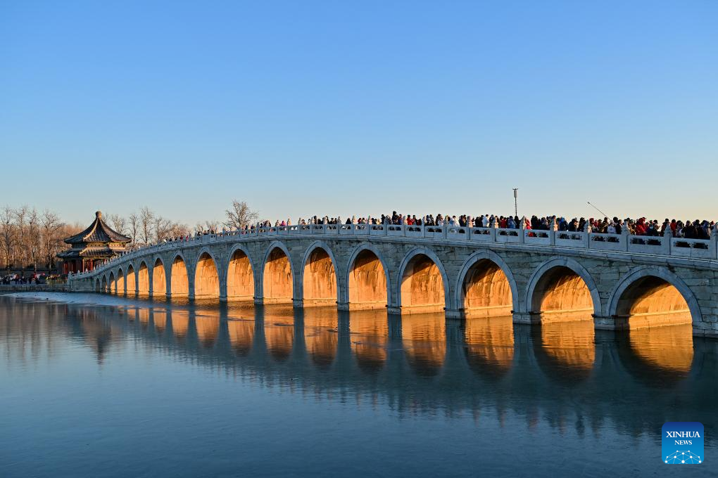 People visit 17-Arch Bridge in Summer Palace, China's Beijing ...