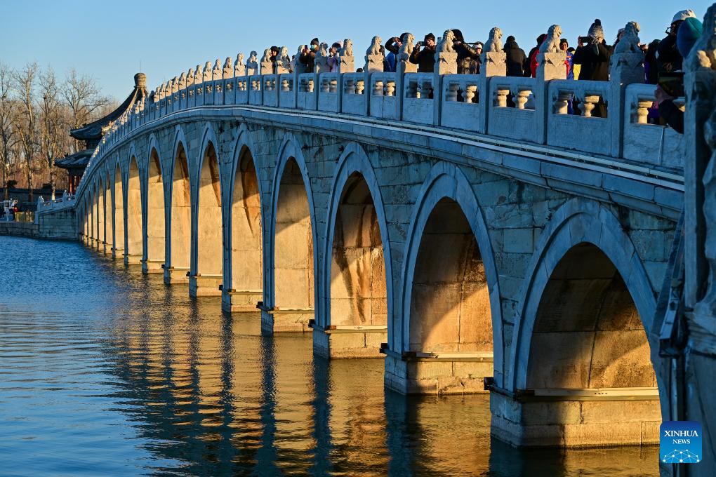 People visit 17-Arch Bridge in Summer Palace, China's Beijing ...