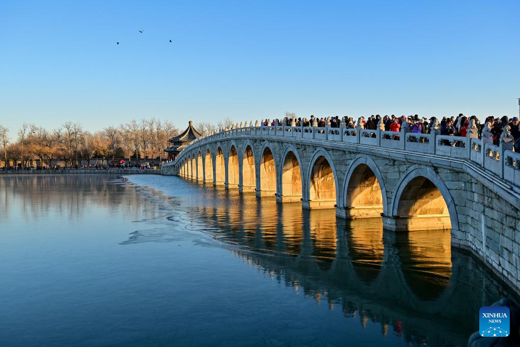 People visit 17-Arch Bridge in Summer Palace, China's Beijing